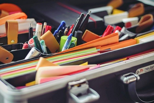 Paper, pens and other supplies in briefcase