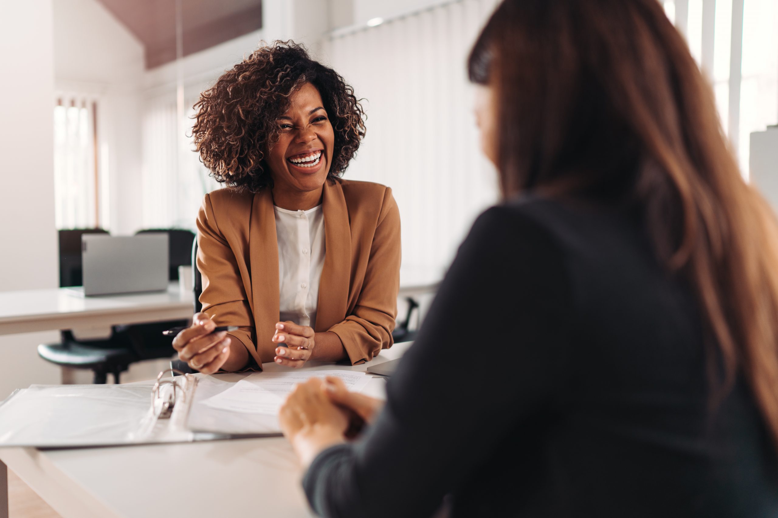 Female mortgage agent consulting a client at the meeting