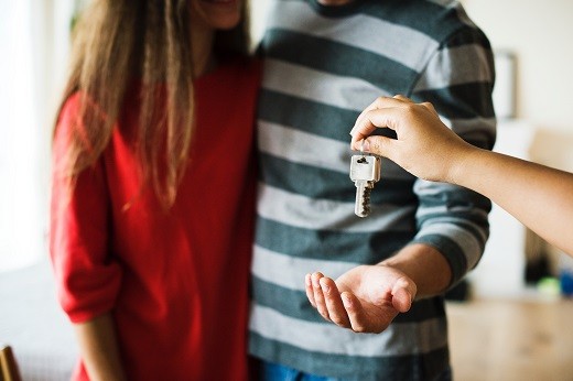 Man and woman receiving key - Educators Financial Group