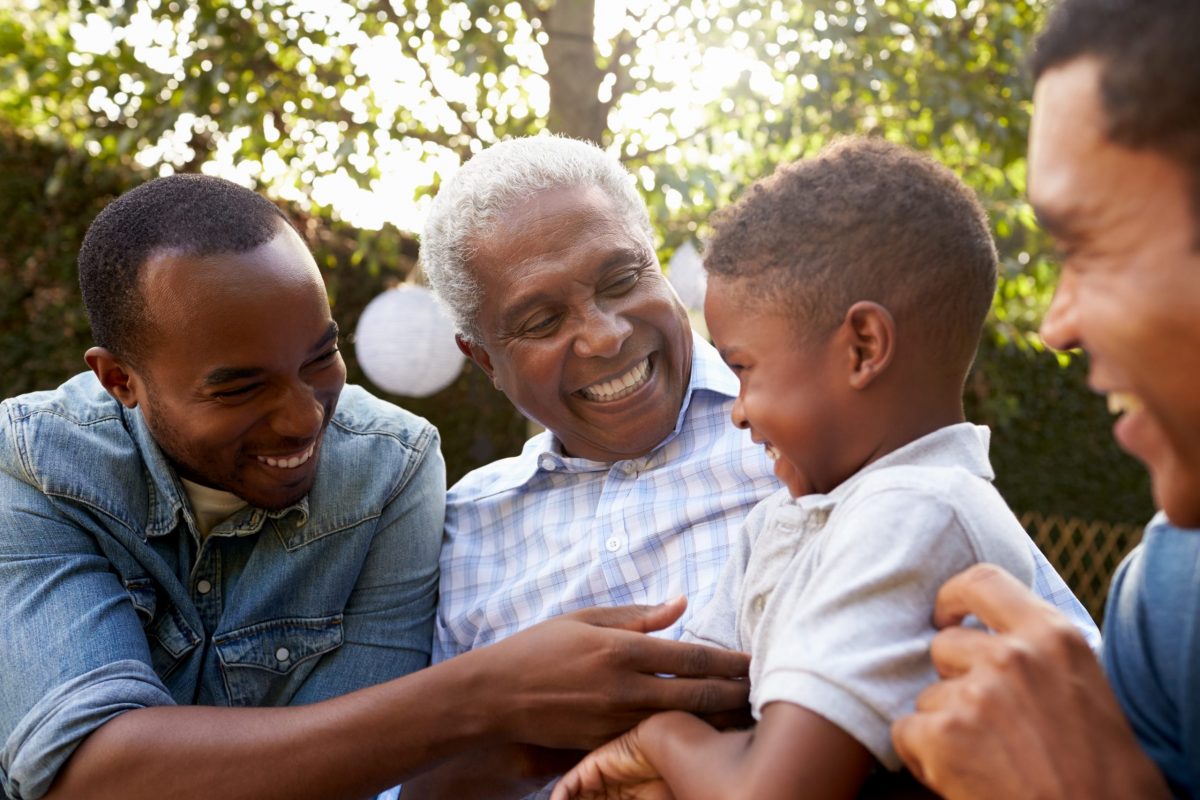 African American grandfather, sons and grandson laughing