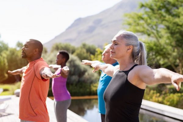 Mature group of people doing breathing exercise