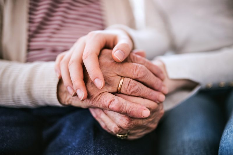 Hands of girl and her grandmother at home.