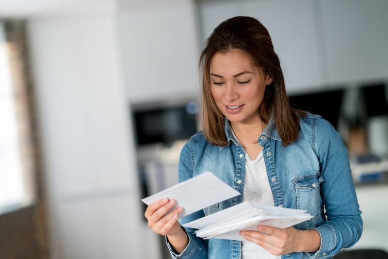 Woman reading her mail at home