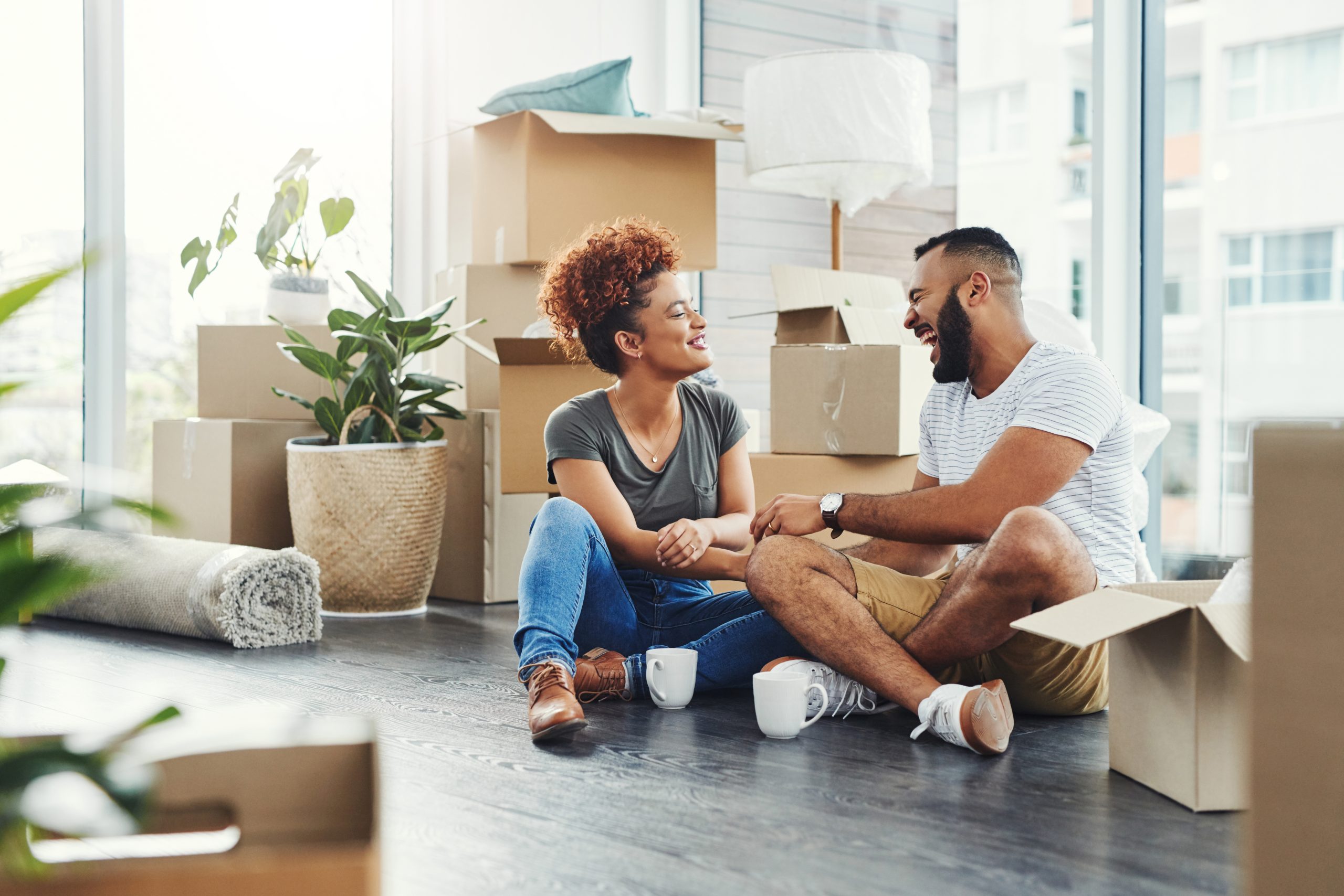 Shot of a young couple taking a break while moving house